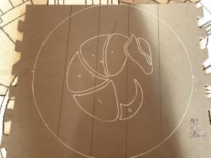 photo of the armadillo design drawn in white marker on a craft foam board