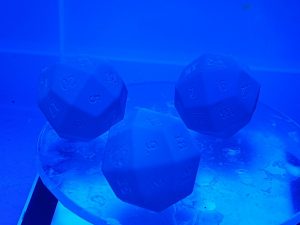 the Glasgow dice curing under blue UV light