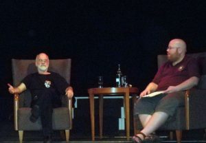 Brian Nisbet sitting across a small table from writer Terry Pratchett