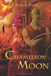 The image shows the cover of RoAnna Sylver’s Chameleon Moon. 2 humanoid but alien looking figures dominate the centre of the image. The one on the right is rendered in more masculine style- they are wearing a brown vest and trousers, their arms are crossed across their chest. They have green scaled skin, pointed ears and a lizard like tongue that flicking out. The figure on the left is rendered in more feminine style, they are wearing a pink flounced dress, their pink hair is piled up in a pompadour threaded with pears on their head. Their skin slightly pink. They are catching a microphone in their hand. 
