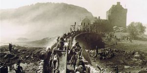still from the film Highlander of a military force leaving a castle via a stone bridge