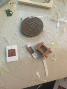 pieces for making tiny furniture, considerably smaller than the penny piece shown for scale.