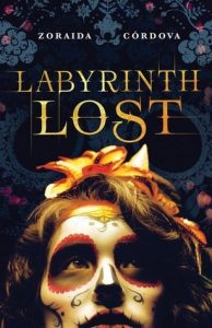 The image shows the cover of Zaoraid Cordova's novel 'Labyrinth Lost'. The lower half of coveris taken up with an upturned face which is covered in make up to resemble a dia de lost murtos skull. They have an orange flower in their hair .