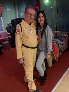 Nicholas Whyte, dressed in Ghostbusters outfit, standing next to a young woman