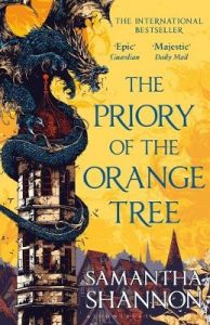 The image shows the cover of Samantha Shannon's novel 'The Priory of the Orange Tree'. The cover shows a sky of orange and gold above a city of peaked roofs. In the forefront on the left-hand side there is a large stone tower with a cupola roof. Around the tower a blue dragon is curled. It dominates the tower and roars out across the city.