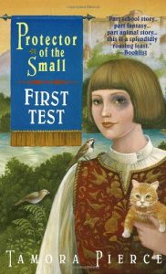 The image shows the cover of Tamora Pierce's novel 'Protector of the Small'. In the forefront dominating the right handside of the cover is a human with a 'page-boy' hair cut of light brown hair and they have a black eye but are smiling gently. They are wearing a red embroidered tabard over a white billowing sleeved shirt. They are carrying a ginger kitten in their right hand. There is a sparrow perched on their left shoulder, another small bird rests on greenery close by. Behind them a landscape stretches to a castle.