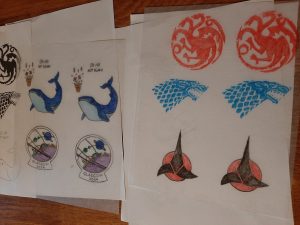 A variety of printed and coloured templates, with logos from Game of Thrones, Star Trek and the Space Whale from A Hitchhiker's Guide to the Galaxy.