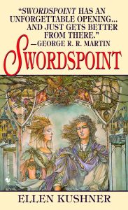 The image shows the original cover art for Ellen Kushner's novel 'Swordspoint'. The image is rendered in mostly washed pastel colours. int he centre of an ornate archway, as part of a cirty, stand two figures one is looking directly out of the cover - their pale hair is blowing in the wind, the one of on the left is facing them. The are wearing ornate and flowing clothes.