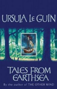 The image shows the cover of Ursula Le Guin's novel 'Tales From Earthsea'. The cover has a blue colour palate. In the centre third of the cover there is a sparse forrest scence of the trunks of trees rendered in greens and blues. In the very centre of that - positioned between two tree trunks - is a regtangular frame of a blue sky and sea, on which a galleon is at full sale. 