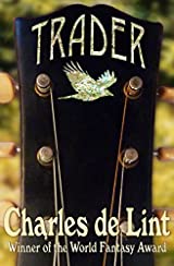 The image shows the cover of Charles de Lint's novel 'Trader'. The cover is taken up by a central image of the headstock of a guitar. It is black wood with bronze fold pegs and strings. Across the top of the guitar the title Trader is embossed in Gold lettering, beneath that is a crow looking bird in flight- this is also embossed in gold.