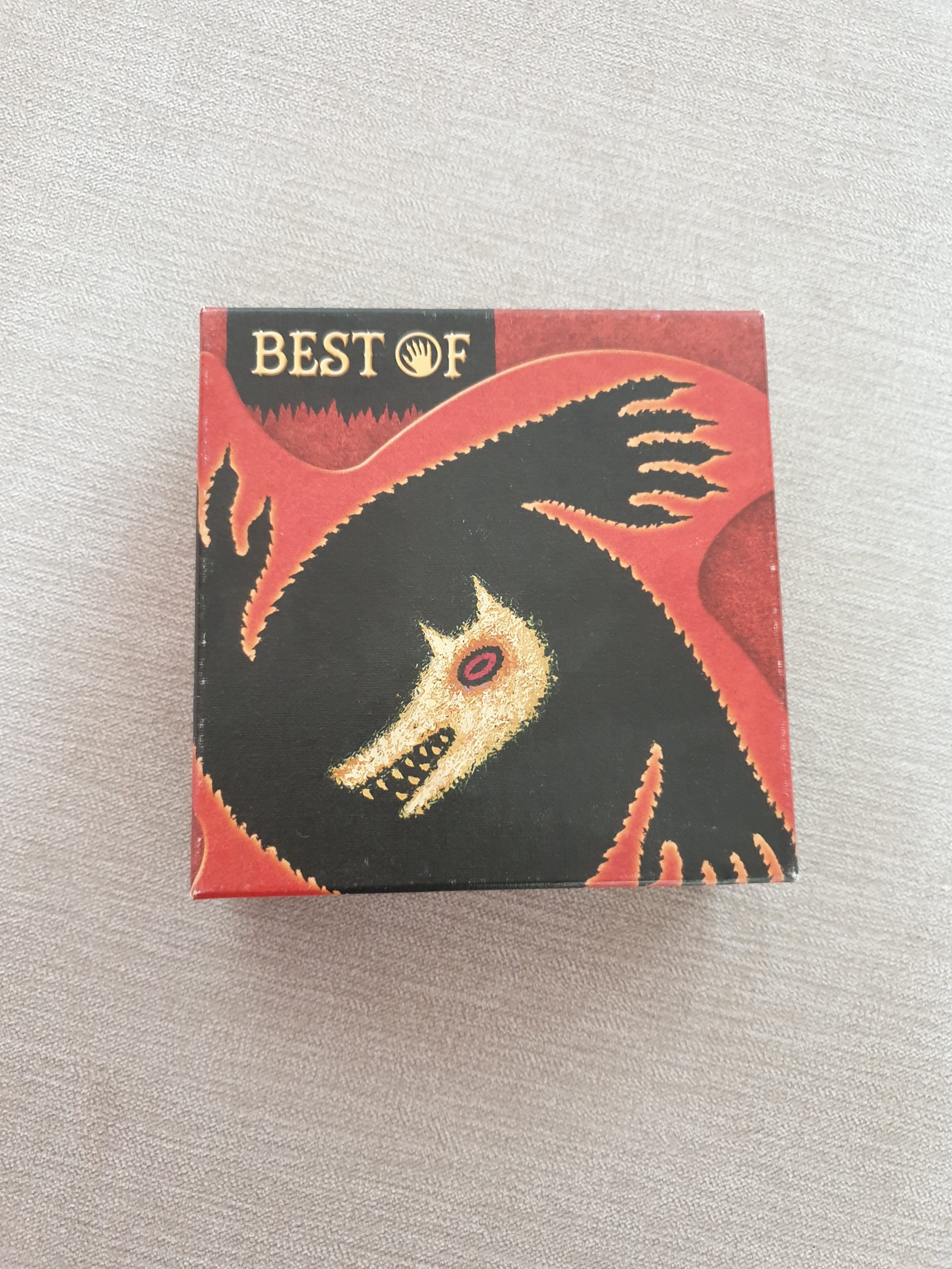 The outer box of the game features a wolf's head inside a spiralling black pattern of wolf's paws, which is in turn inside a spiralling red pattern. The words 'Best of' are printed on the top left of the box.
