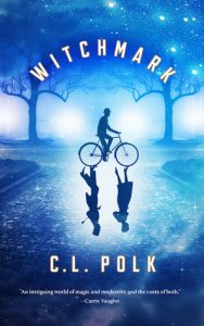 Image shows cover of C.L. Polk's novel 'Witchmark'. Everything is rendered in tonal shares of blue. The scene showers a street with frame of trees in the background. In the centre of the image a male figure in a bowler hat rides a bicycle, where the reflection would be there is instead an inverted image of a couple talking.