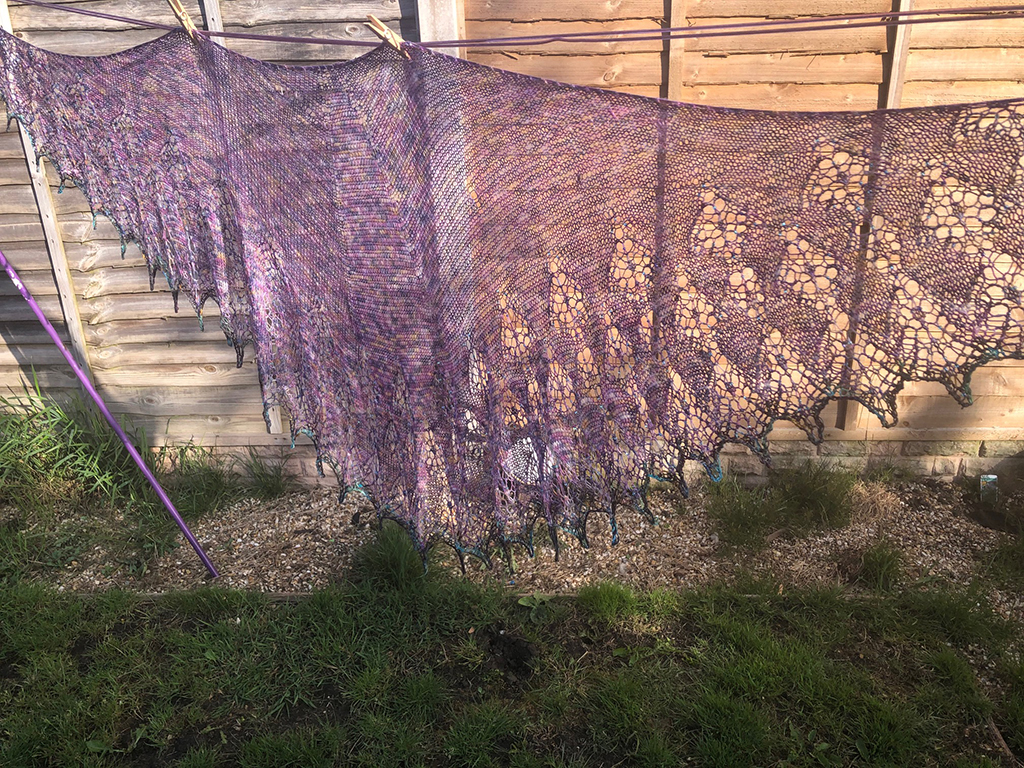 Photograph of Alba Aether Shawl being blocked.