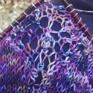 Photograph of alba aether yarn on knitting needles