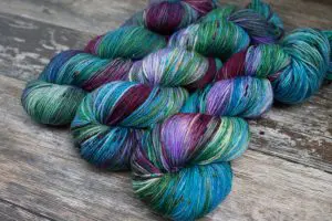 Skein Dubh: A skein of yarn in a variegated colourway, inspired by the colours of our official tartan