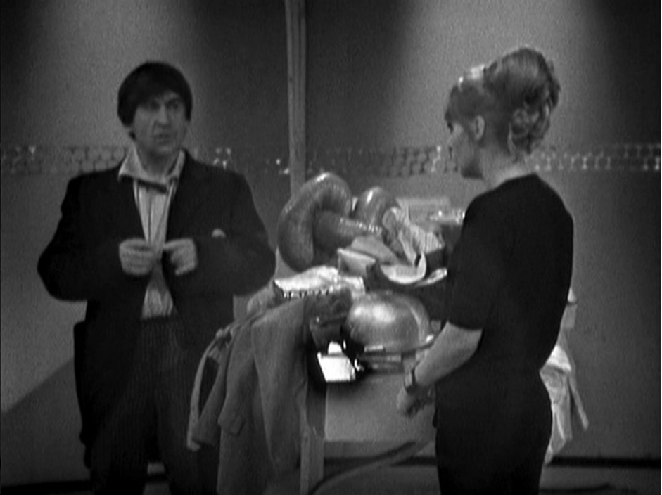“The Doctor (Patrick Troughton) and his companion Polly (Anneke Wills) standing next to each other.”